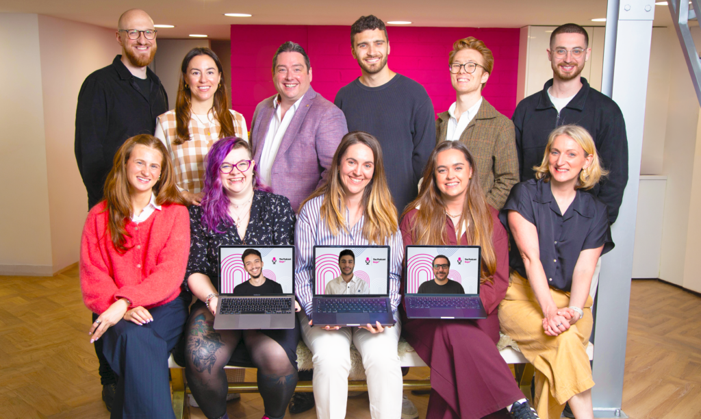 The Podcast Guys team at their London branded podcast agency HQ, with remote team members joining on laptop screens